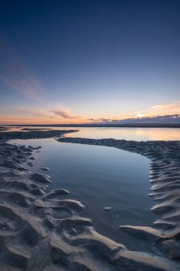 Tranquil colorful sunset over sea, viewed from the dutch coast. The Netherlands