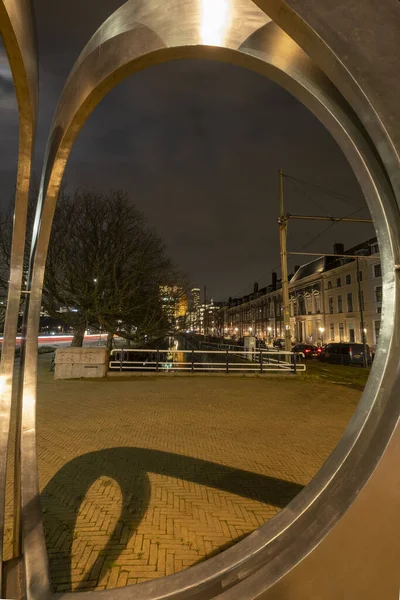 The Hague, the Netherlands - 18 February 2019: Koninginnegracht. Artwork: Pressed circles by Andre van Lier. Golden circles with a view of the high buildings, Castalia, Helicon, de Zurichtoren en de — Stock Photo, Image