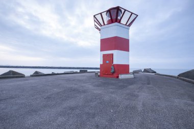 Scheveningen, Februari 18 2019: Scheveningen, The Hague, The Netherlands.Lighthouse at sunset, blue sky with copy space, Scheveningen, The Netherlands