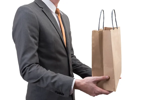 Biznesmen posiadający worek na zakupy na białym tle — Zdjęcie stockowe