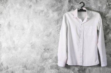 Grunge arka plan üzerinde uzun kollu beyaz gömlek. Metin için boş alan