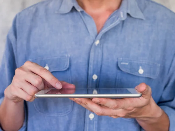 Close up of Casual man using a tablet, communication concept