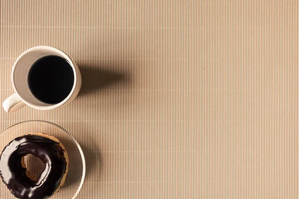 Top view of coffee cup with donut on table. Free space for text — Stock Photo, Image