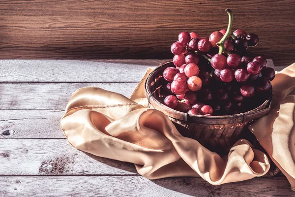 Червоний виноград в кошику на дерев'яному столі. Вільний простір для тексту — стокове фото