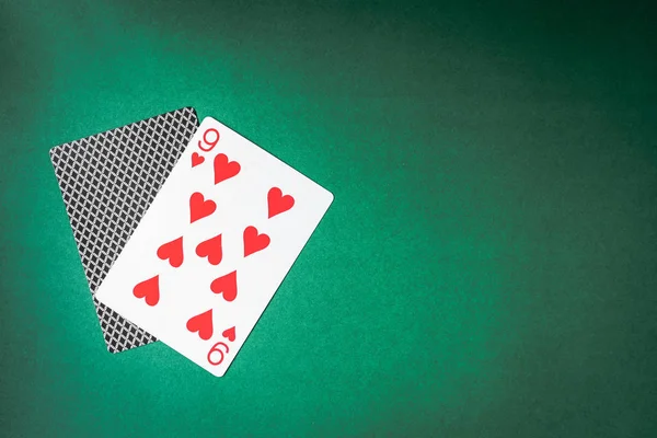 Playing card and back designs on green background. Free space for text