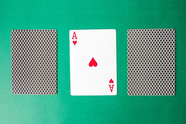 Playing card and back designs on green background. Free space fo