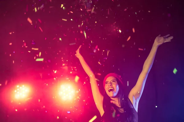 Mujer feliz bailando bajo el confeti en una fiesta — Foto de Stock