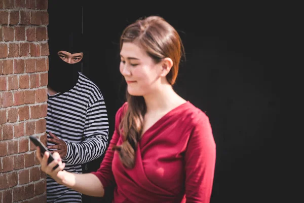 Thief is looking at asian woman, who is walking alone, and waiting for steal her phone. — Stock Photo, Image