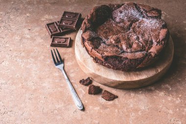 Ahşap tepsi çatal ile çikolatalı kek.