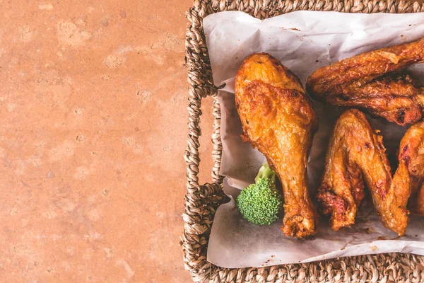 Top view of Fried chicken legs and wings in basket. Free space for text — Stock Photo, Image