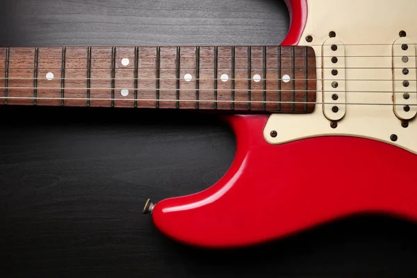 Close up of Electric guitar body and neck detail on black background. Royalty Free Stock Images