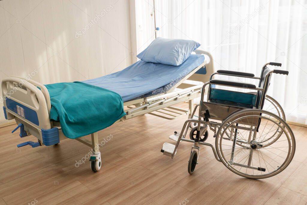 Hospital bed and wheelchair at the hospital room