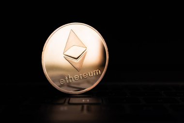Bilgisayar klavyesinde ethereum sembolü olan altın bir sikke..