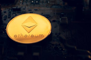 Üzerinde ethereum sembolü olan altın bir sikke..