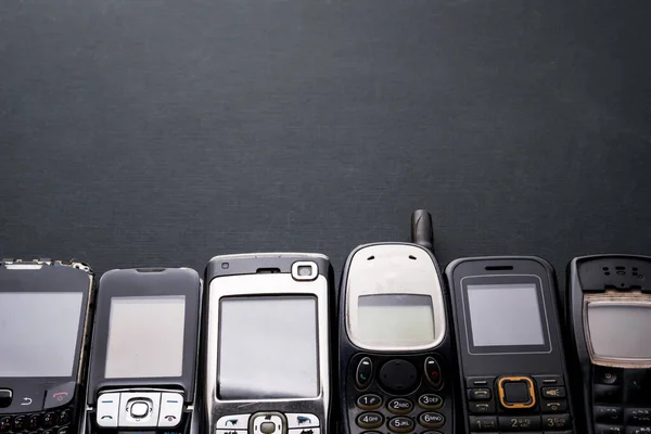 Old Obsoleted Cellphones Black Background — Stock Photo, Image