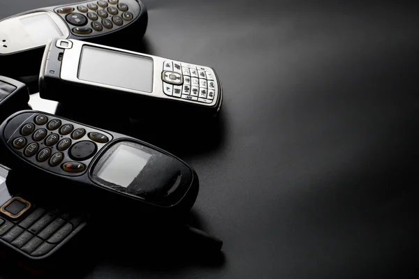 Old Obsoleted Cellphones Black Background — Stock Photo, Image