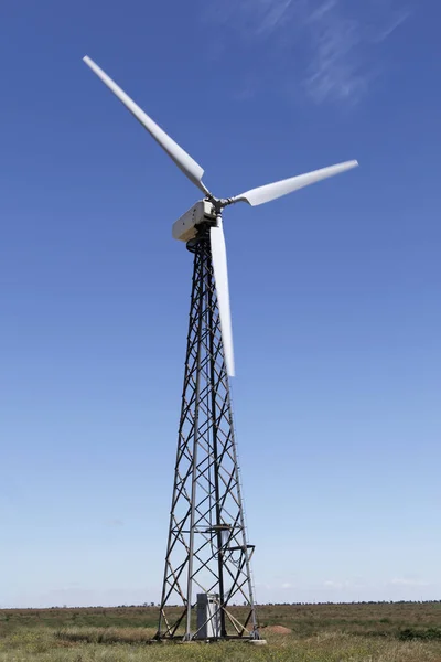 Wind turbine against a blue sky. Alternative energy.