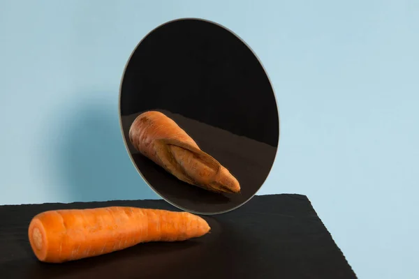 Ugly carrots. Reflection in the mirror. Concept-low self-esteem. Copy space.