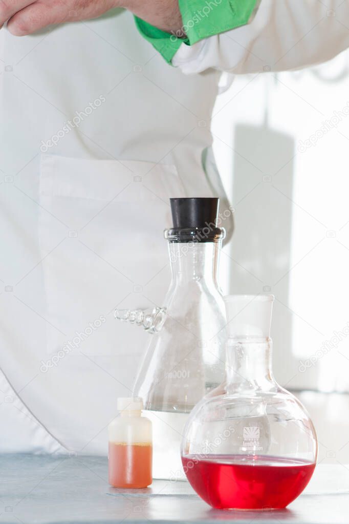 Transparent laboratory flasks with multi-colored reagents. Closeup. Selective focus. 
