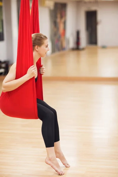 young girl do fly yoga and stretches in the studio