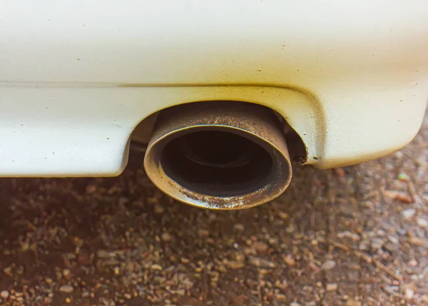 dirty white sports car exhaust