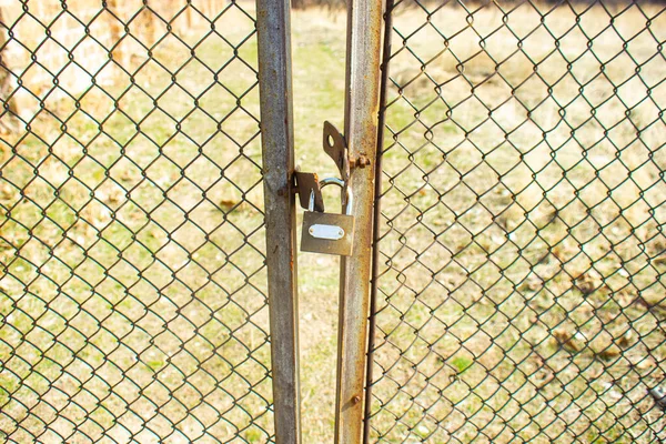 the gate of a secret chemical factory locked with iron lock