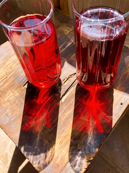 glass of red juice, glass of red juice on wooden table, red juice in a glass