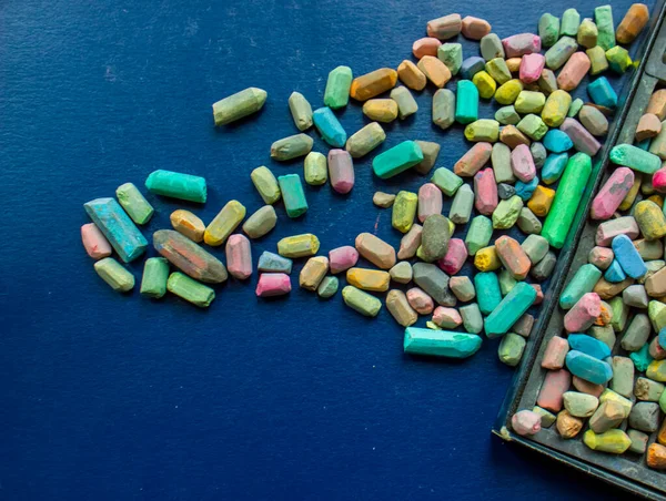 colorful pills on a blue background, colorful chalks on blue background