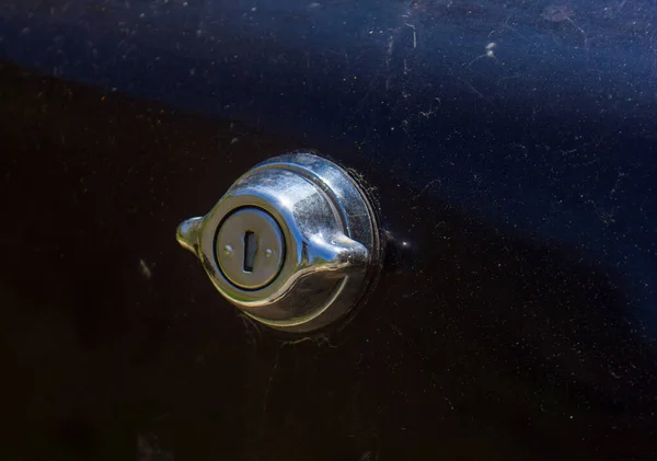 door handle with lock, old car lock on dark background