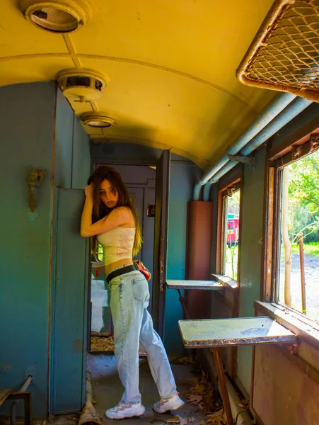 young woman in the old train, young woman in a train, sexy young girl standing in a train