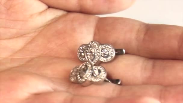 宝石店で彼女の手でイヤリングを見て女性 ダイヤモンドと手 ダイヤモンドを保持する手 — ストック動画