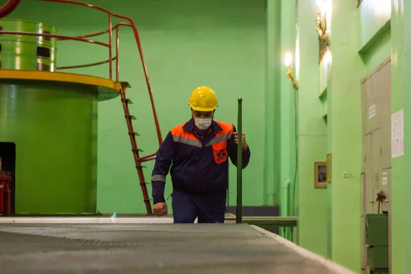 construction worker on construction site, worker in protective mask, worker in medical mask, construction worker with yellow helmet