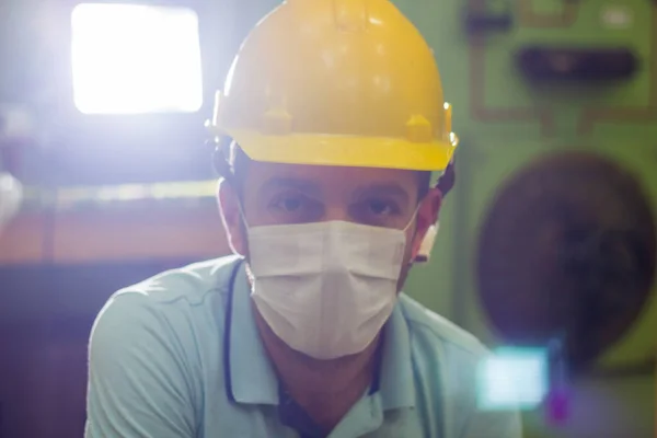 worker in protective mask, worker in medical mask, construction worker with yellow helmet