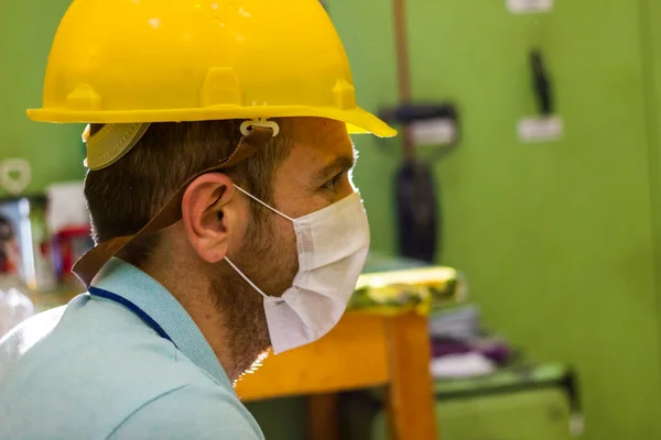 worker in protective mask, worker in medical mask, construction worker with yellow helmet