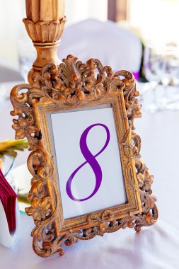 Gold frame with a number of the decorated table with the number  clipart