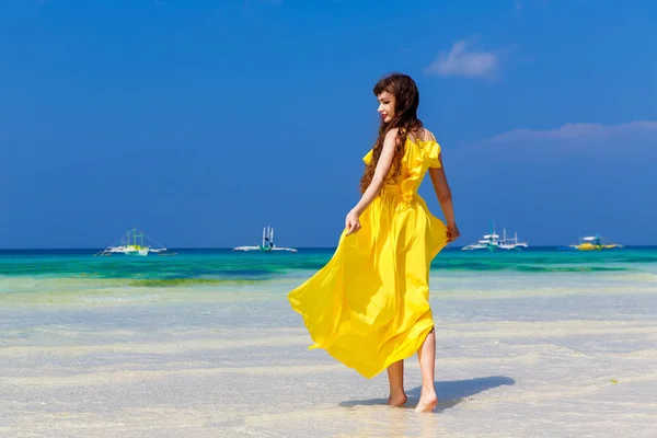 Krásná brunetka žena v žlutých šatech s ji zpět do vi — Stock fotografie