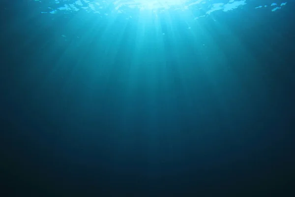 Deep blue ocean water with shining sunrays