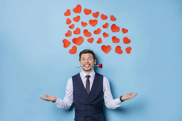 happy caucasian man in tux isolated over blue background