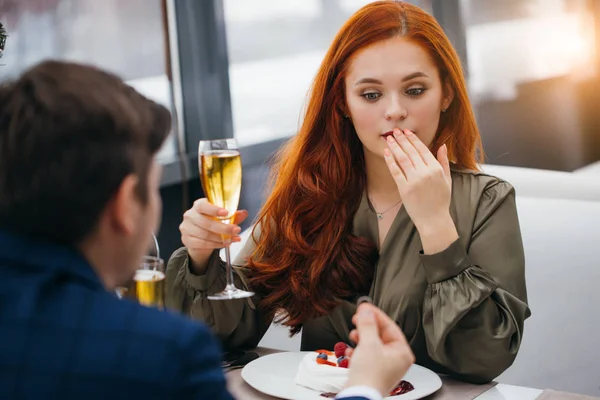 surprised woman with man in restaurant