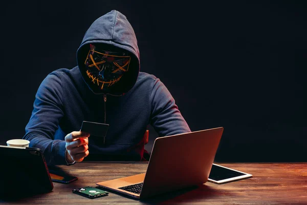 Aggressive hacker man with laptop isolated in dark space — Stock Photo, Image