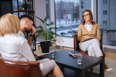 Üzgün ve mağdur evli çift profesyonel psikologu ziyaret ediyor.