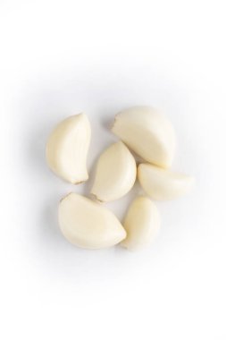 organic food concept. peeled garlic cloves isolated on white clipart