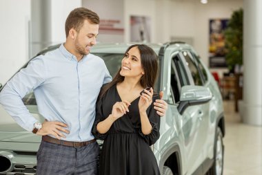 portrait of lovely married couple in dealership