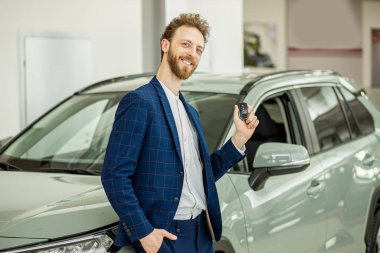 positive smiling happy man buyer in dealership