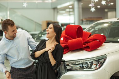 surprised lady surprisingly look at man, celebration of car purchase