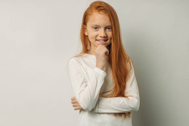 sweet little girl with natural red hair isolated