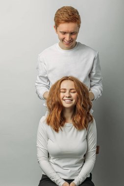 redhead guy touch womans hair