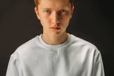 handsome redhead guy isolated over black background
