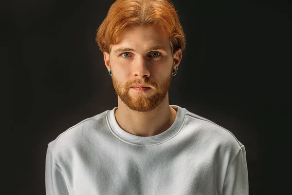 Portrait of serious redhead guy isolated over black background — Stock Photo, Image