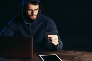 man hacking bank card using computer system